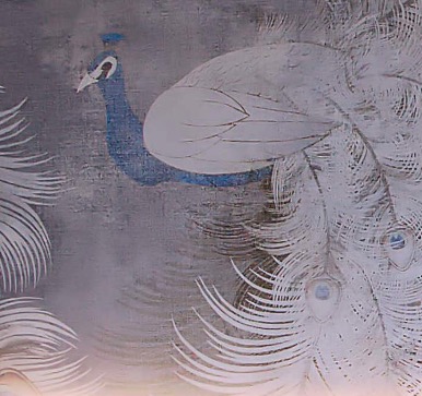 Detail of the peacock wallpaper behind the bed